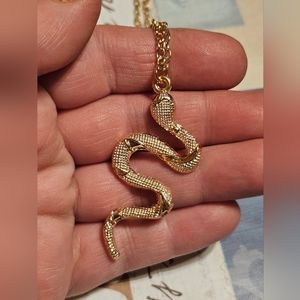 Gold tone snake pendant necklace